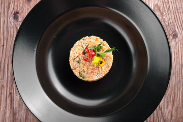 Couscous on a black plate