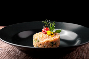 Couscous on a black plate