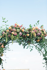 close up of wedding arch decorated with pink flowers, ornate bohemian wedding