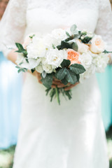 bride holding classic pink and white peony flower bouquet 