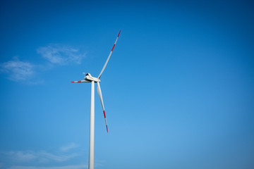 Close up of a wind turbine on a blue sky