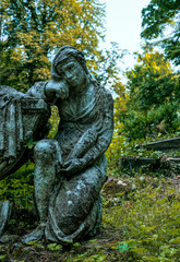 Marble statue and an ancient abandoned Gothic cemetery	
