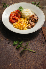 rice, vegetables and meat (corn, tomato salsa, greens, vegetables) portion serving. top food background. copy space