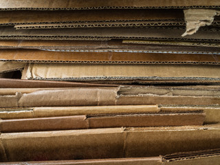 Old cardboard boxes are crumpled. A pile of cardboard boxes prepared for disposal