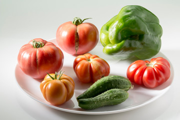 Ugly freak organic tomato and cucumber and pepper on a white background. The concept of organic vegetables.