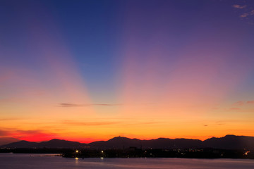 Vibrant and colorful purple sunset with silhouette of mountains/Colorful sunset behind mountains of tropical island/Sky after sunset a beautiful colorful/Beautiful twilight sky and landscape/