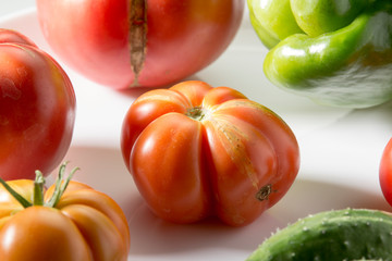 Ugly freak organic tomato and cucumber and pepper on a white background. The concept of organic...