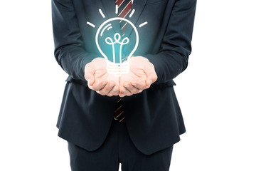 cropped view of businessman with cupped hands near light bulb isolated on white