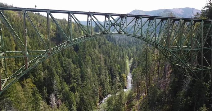 Flying Under Massive Abandoned Vance Creek Bridge Over Deep Canyon. Aerial of Historic Landmark in Washington State Usa