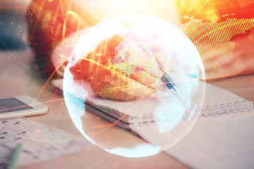 International business hologram over hands taking notes background. Concept of success. Multi exposure