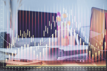 Forex market graph hologram and personal computer on background. Multi exposure. Concept of investment.