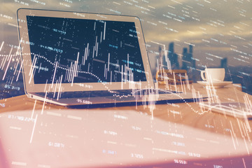 Forex market graph hologram and personal computer on background. Multi exposure. Concept of...