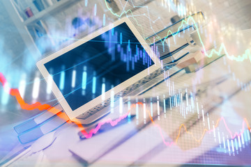 Stock market graph and table with computer background. Double exposure. Concept of financial analysis.