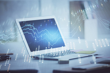 Forex graph hologram on table with computer background. Multi exposure. Concept of financial markets.