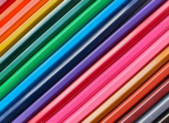 Wooden colored pencils background, close up rainbow style, diagonal layout. Copy space for text
