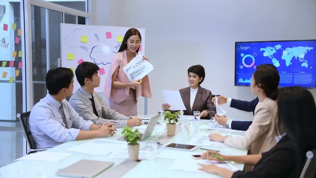 Business concept. Young businessmen are distributing documents to present their work.