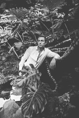 Fototapeta na wymiar Young man resting among the vegetation