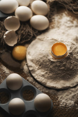 eggs and flour on wooden table
