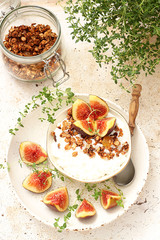 Healthy breakfast with cottage cheese, granola and figs 