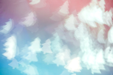 Blurred blue background with bokeh in the shape of fir tree. Abstract texture with soft focus