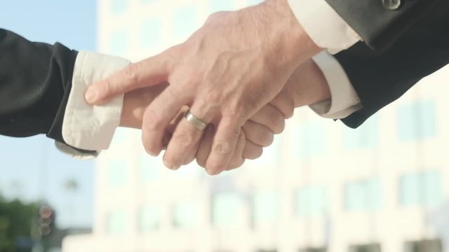 Slow-Motion, Business Man And Woman Shake Hands In Real Time In Front Of Corporate Office