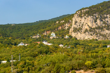 Christian temple on the top of the mountain on a bright sunny day with clouds in the sky.