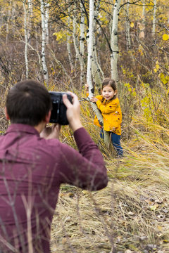 Man photographing little girl