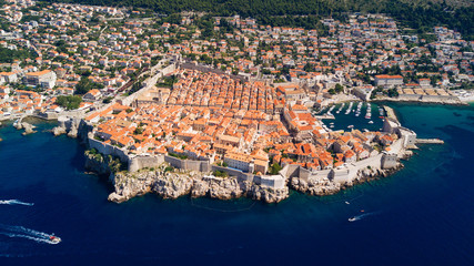 Dobrovnik, Croatia from above. Aerial drone footage of the historic city of Dubrovnik. City walls, blue sea and harbour.