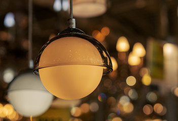 Round white lamp in a glass lampshade.