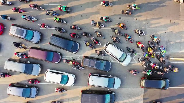 JAKARTA, Indonesia - August 07, 2019: Top down time lapse view of crowded cars and motorcycle moving on traffic congestion during rush hour. Shot in 4k resolution from a drone