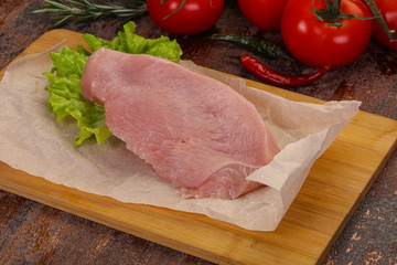 Raw Turkey steak served rosemary