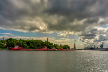 Fototapeta premium Port of Gdansk, Poland. Tugboats are awaiting the waterfront, in the depths of the Westerplatte monument