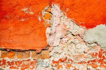 Brick wall in stucco crumbling orange loft texture background