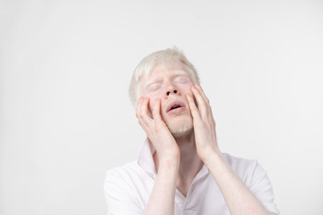 portrait of an albino man in  studio dressed t-shirt isolated on a white background. abnormal deviations. unusual appearance