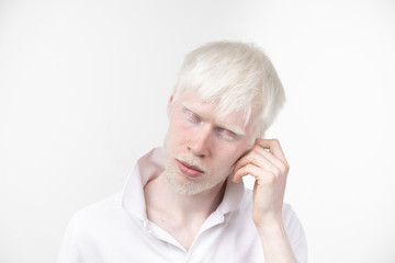 portrait of an albino man in  studio dressed t-shirt isolated on a white background. abnormal deviations. unusual appearance