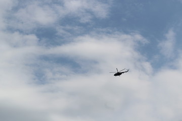 Fototapeta na wymiar silhouette of big military helicopter in the sky