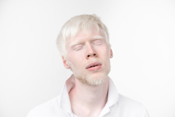 portrait of an albino man in  studio dressed t-shirt isolated on a white background. abnormal deviations. unusual appearance