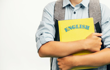 Kid with schoolbag and English books closeup