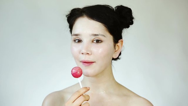 Beauty Portrait close up with baby face makeup and Candy. Portrait of a young pretty girl