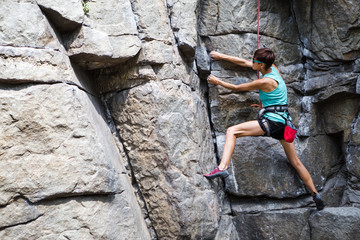 Rock climber is training on natural terrain.