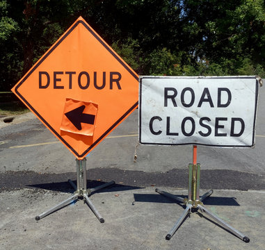 ROAD CLOSED and DETOUR sign on neighborhood street.