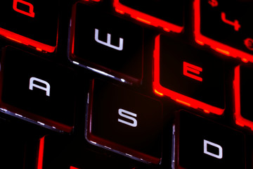 Red backlit keyboard on black background. High resolution image for gaming industry.