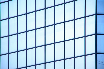 A high-rise office building with blue glass windows