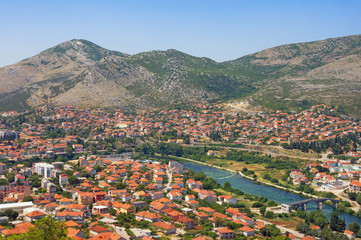 Fototapeta na wymiar View of Trebinje city and Trebisnjica river on sunny summer day. Bosnia and Herzegovina
