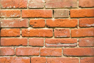 Old red vintage bricks in the wall close up