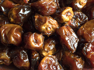 Delicious organic sweet dates in bowl with syrup.