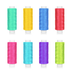 collection of colorful spools of thread isolated on white background