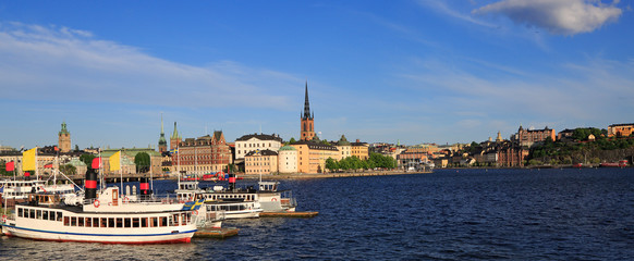 Scenic panoramic view of Stockholm's Old Town (Gamla Stan) late afternoon with a passenger ship on...