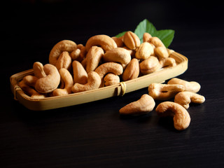 Cashew nuts on dark background. Selective focus.