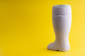 Vertical White Beer boot on a yellow Background